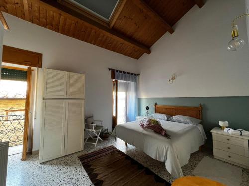 a bedroom with a bed and a large window at Locazione Culturale - Short Rent in Atri - in Atri