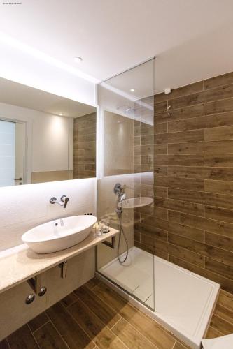 a bathroom with a sink and a glass shower at Hotel Nar in Trebinje