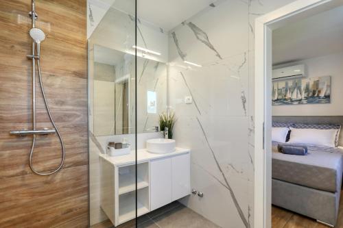 a bathroom with a shower and a sink at Holiday home Fjaka with swimming pool in Pridraga