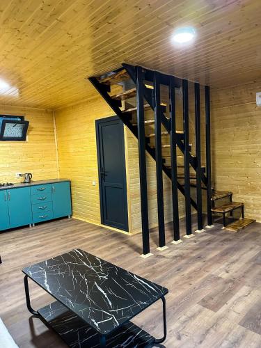 a room with a staircase and a table in a room at Martvili canyon cottage in Martvili