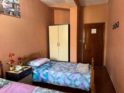 a bedroom with a bed and a dresser and a cabinet at Brazil hotel in Peshkopi