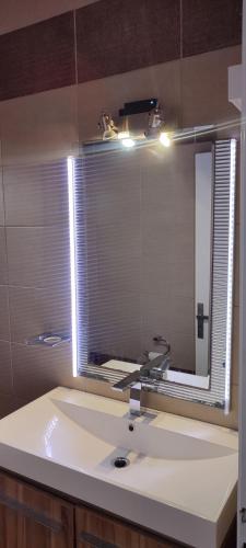 a bathroom with a sink and a mirror at aggelos home in Kato Alepochori