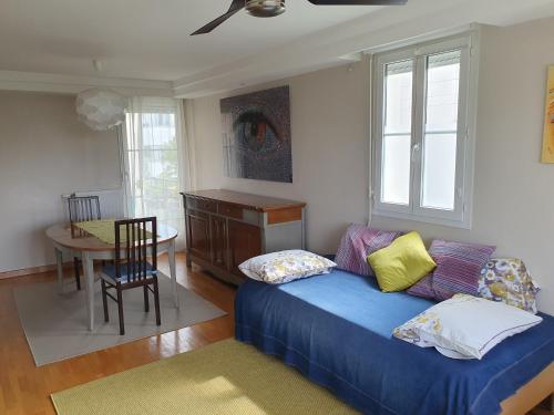 un salon avec un canapé et une table dans l'établissement Appartement résidentiel au vert et au frais, à Montigny-le-Bretonneux