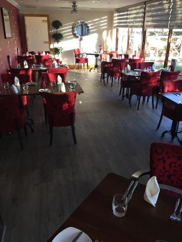 a dining room with tables and chairs and a restaurant at Seafield Arms Hotel in Whitehills