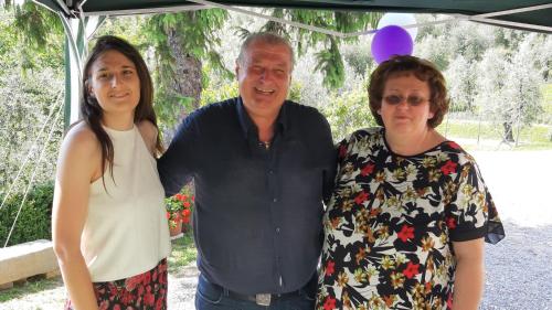 a man and two women standing under a canopy at Agriturismo Il Bel Vedere in Marliana