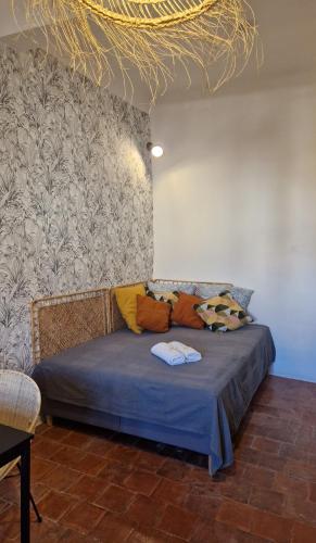 un lit avec des oreillers dessus dans une chambre dans l'établissement Studio de charme hypercentre d'Aix, à Aix-en-Provence