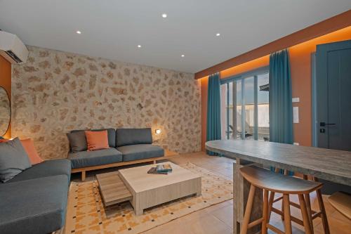 a living room with a couch and a table at Tessera Villas & Studios Collection in Gouvia