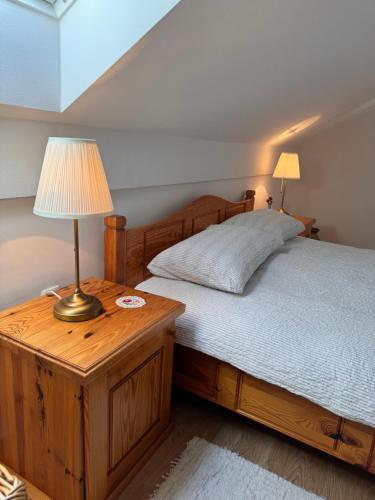 a bedroom with a bed with a lamp on a wooden table at Holiday home Ana in Fokovci