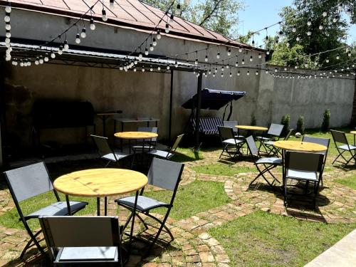 a group of tables and chairs in a yard with a piano at Arevaham Boutique Hotel in Stepʼanavan