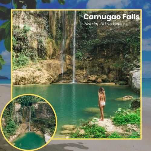 a woman standing in the water in front of a waterfall at Eco Glamping Treehouses Closest Resort To All Tourist Attractions in Balilihan