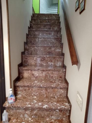 a stairway with a marble floor and a stair case at Villa Carolina in Fara San Martino