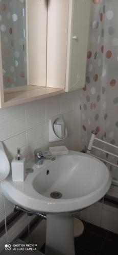 a bathroom with a white sink and a cabinet at La casetta dei sogni in Perugia