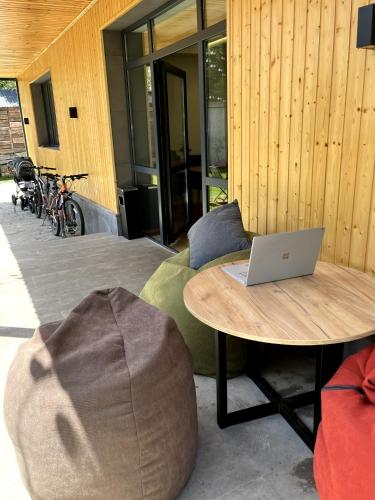 a room with a bed with a laptop on a table at Arevaham Boutique Hotel in Stepʼanavan