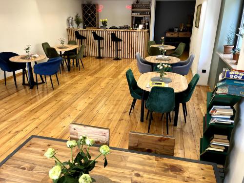a restaurant with wooden floors and tables and chairs at Arevaham Boutique Hotel in Stepʼanavan