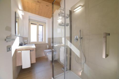 a bathroom with a shower and a toilet and a sink at La Piazzetta Holiday House in Serra deʼ Conti