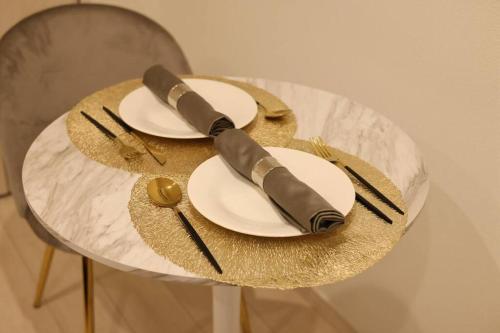 a table with two white plates with at Miu Hotel Shinagawa - Tokyo Travel Hub near Landmarks, Bullet Train & Airport in Tokyo