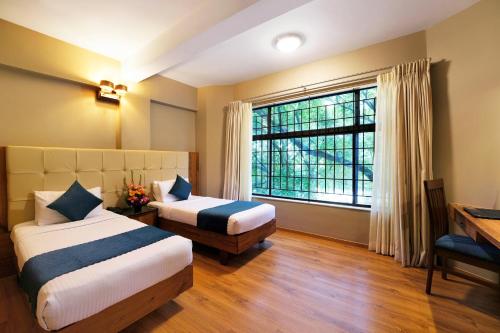 Katil atau katil-katil dalam bilik di Cross Roads Inn