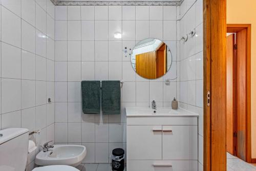 un bagno con lavandino, WC e specchio di Lisbon Beach Flat - 4 Guests - Free Parking a Costa da Caparica