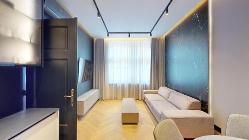 a living room with a couch and a window at Naprstek Urban Retreat in Prague