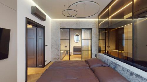a bedroom with a large bed and a bathroom at Naprstek Urban Retreat in Prague