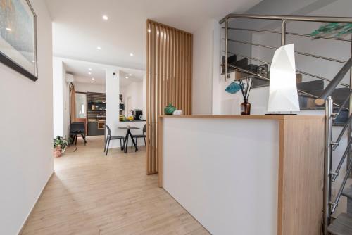 a kitchen and living room with a counter and a table at Room 86 in San Vito lo Capo