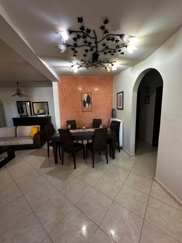 a living room with a table and chairs and a couch at Evdokiahouse in Áno Kalésia