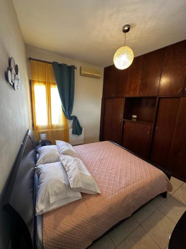 a bedroom with a bed with a wooden cabinet at Evdokiahouse in Áno Kalésia