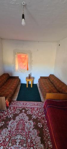 a room with two beds and a table in it at Babina djeca in Pljevlja