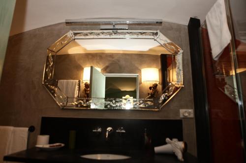 a mirror above a sink in a bathroom at Casa Bormioli - Maison de Charme in Procida