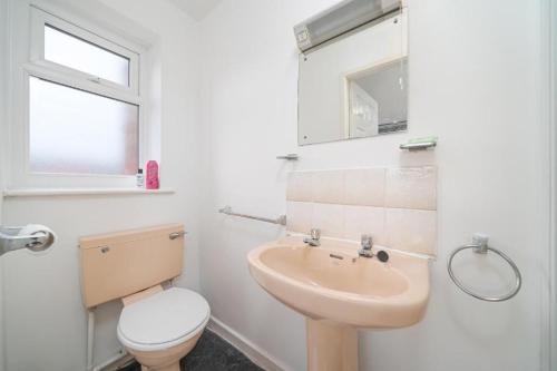 a bathroom with a sink and a toilet at Deneside Guest House in Blackpool