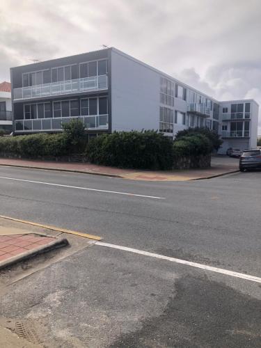 a large building on the side of a street at 1 BR Oceanview - Glenelg South in Glenelg