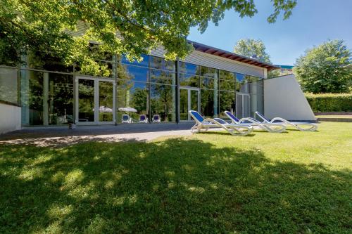 a group of chairs in front of a building at Seminaris Hotel Bad Boll in Bad Boll