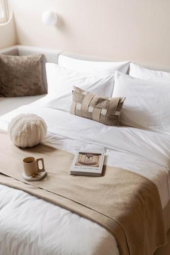 a bed with a book and a cup of coffee on it at Lore Hotel in Taipei