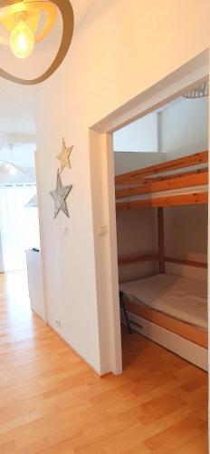 une chambre avec un lit superposé avec une étoile sur le mur dans l'établissement Studio cabine nouveau ! 1ère ligne vue mer PARKING WIFI - Impérial 2 - ROSSIconciergerie - Linge en option, à La Grande Motte