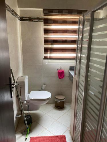 a small bathroom with a toilet and a window at Family-Friendly Chalet at Piacera, Ain Sokhna in Ain Sokhna