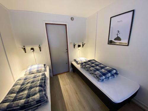 a room with two beds in a room with a door at Åsarna Skicenter in Åsarne