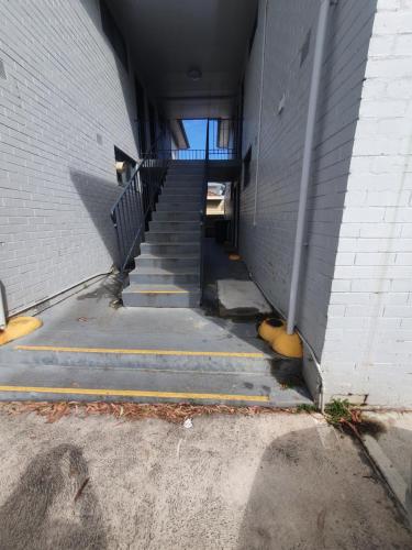a stairway leading up to a building at Zen Queendom - Garden View in Newport