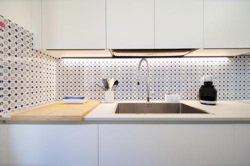 a kitchen with a sink and a counter top at Singer House in Center Town in Lucca