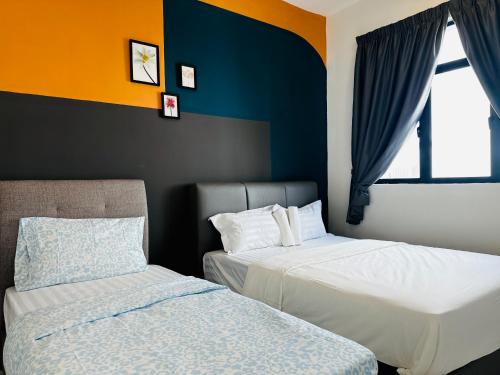 two beds sitting next to each other in a bedroom at The Sun 1 or 3BR Bayan Lepas 4 to 10 pax WL in Bayan Lepas
