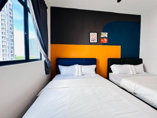two beds in a room with two windows at The Sun 1 or 3BR Bayan Lepas 4 to 10 pax WL in Bayan Lepas
