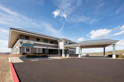 a large building with a gas station in a parking lot at Travelodge by Wyndham Globe AZ in Globe