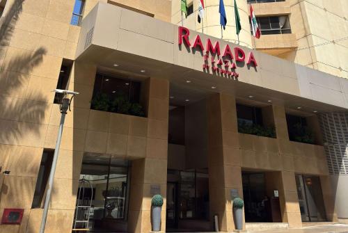 a building with a sign on top of it at Ramada Plaza by Wyndham Beirut Raouche in Beirut
