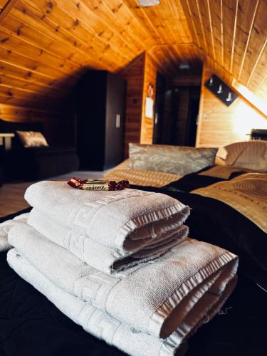 a pile of towels sitting on top of a bed at Willa Amaretto in Wisła
