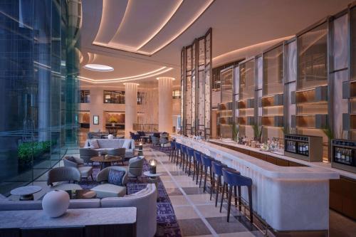 a hotel lobby with a bar and tables and chairs at Grand Hyatt Beijing in Beijing