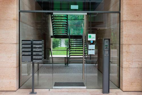 a glass door with a parking meter in front of a building at La Casa di Vale Muse in Trento