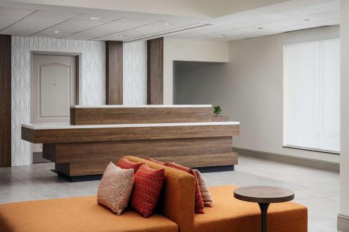a lobby with a couch with pillows on it at Hilton Garden Inn Huntsville South/Redstone Arsenal in Huntsville