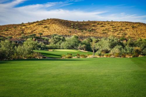 a golf course with a hill in the background at Hilton Phoenix Tapatio Cliffs Resort in Phoenix