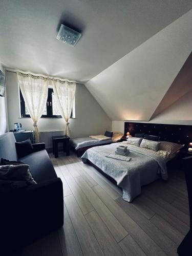 a large bedroom with two beds and a couch at Willa Amaretto in Wisła