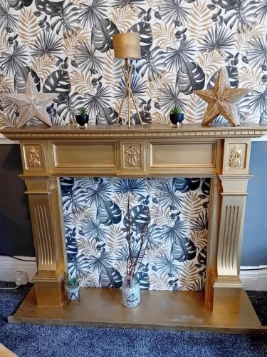 a wooden table with a lamp and some plants on it at The Beckwood Hotel in Blackpool