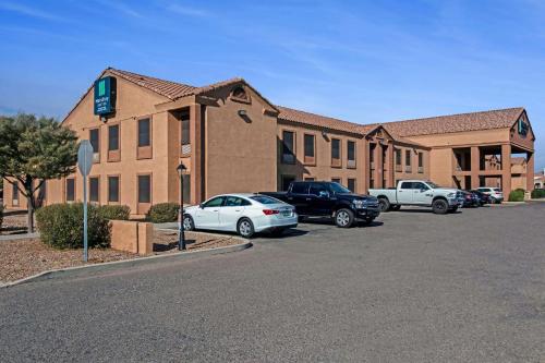 a building with cars parked in a parking lot at MainStay Suites Extended Stay Hotel Casa Grande in Casa Grande